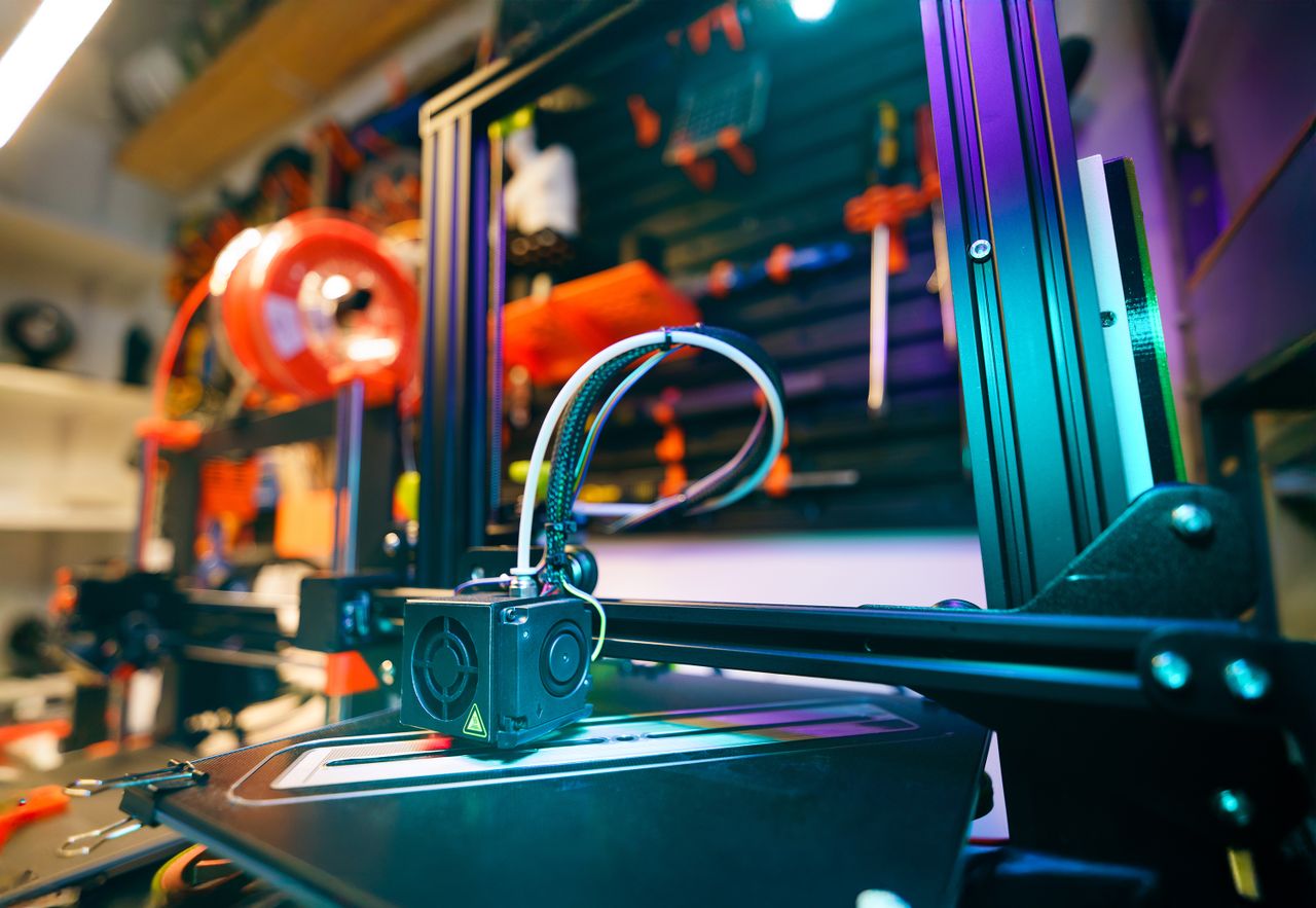 Crafting Captivating Headlines: Your awesome post title goes here A close-up shot of a 3D printer in a vibrant and modern workshop environment.